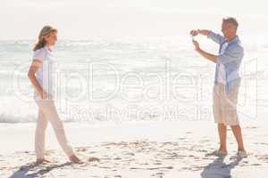 Man taking a photo of his smiling partner