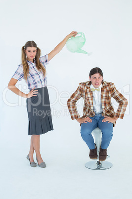 Geeky hipster watering her boyfriend