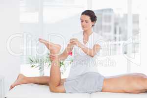 Physiotherapist using reflex hammer