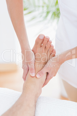 Physiotherapist doing foot massage