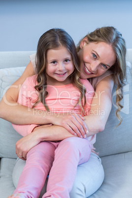 Father and daughter hugging on couch