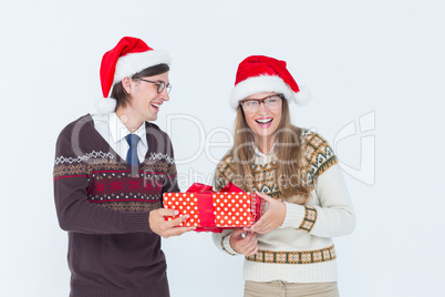 Geeky hipster couple holding present