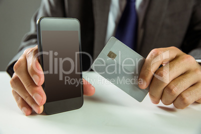 Businessman using smartphone for online shopping