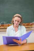 Teacher reading papers at her desk