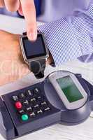 Man using smart watch to express pay