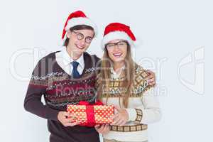 Geeky hipster couple holding present