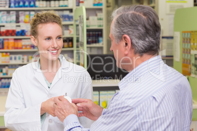 Pharmacist explaining something to a customer