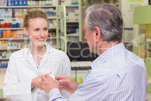 Pharmacist explaining something to a customer