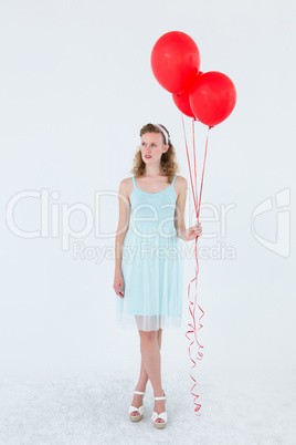 Happy hipster woman holding balloons