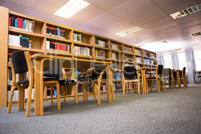 Volumes of books on bookshelf in library