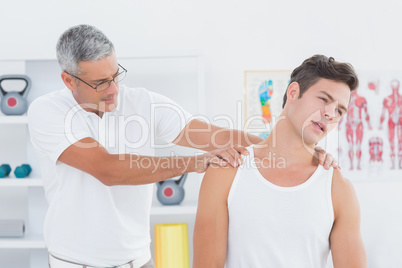 Doctor examining his patient neck