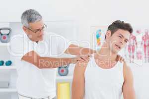 Doctor examining his patient neck