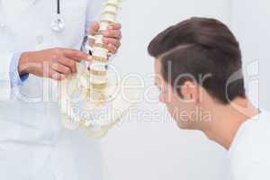 Doctor explaining anatomical spine to his patient