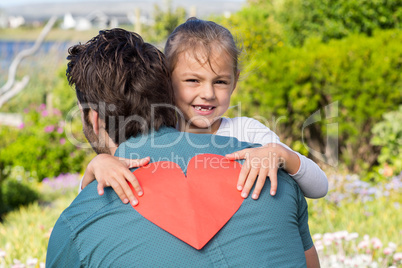 Daughter giving dad a heart card