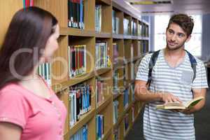 Students in the library smiling at each other