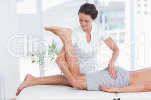 Physiotherapist doing leg massage to her patient