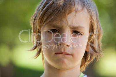 Sad little boy in the park