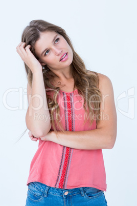 Thoughtful woman with hand on her hair