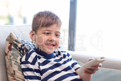 Little boy watching tv on the couch