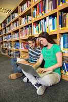 Students sitting on floor in library