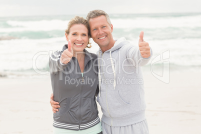 Fit couple smiling at camera