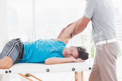 Doctor examining his patient arm