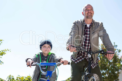 Happy father on a bike with his son