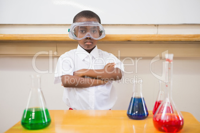 Serious pupil looking at camera with arms crossed