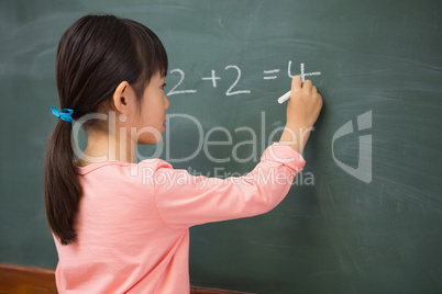 Pupil writing numbers on a blackboard