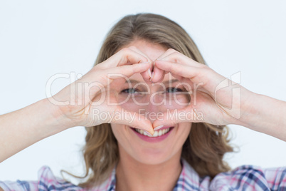 Smiling hipster doing heart shape with her hands