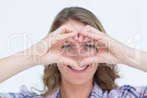 Smiling hipster doing heart shape with her hands