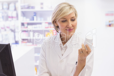 Pharmacist holding medicine jar