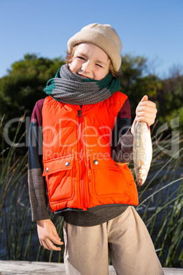 Cute boy holding fish