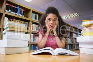 Pretty student studying in the library