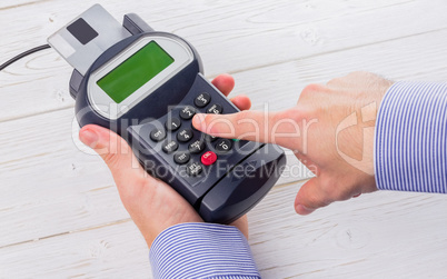 Man entering his pin on terminal