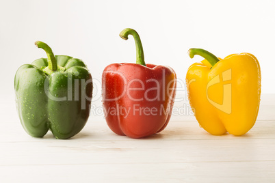 Three peppers on chopping board