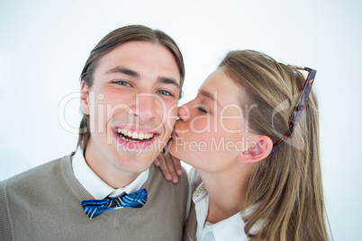 Pretty geeky hipster giving boyfriend kiss on the cheek