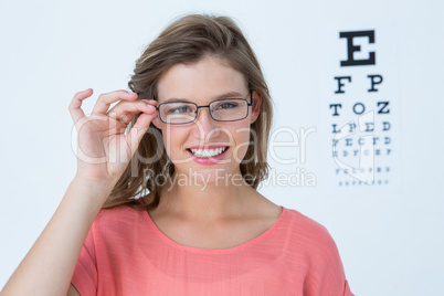 Hipster with eyeglasses and eyes test behind her