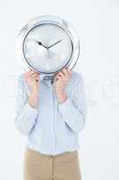 Businesswoman in suit holding a clock