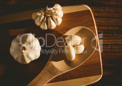 Garlic cloves and bulb on chopping board