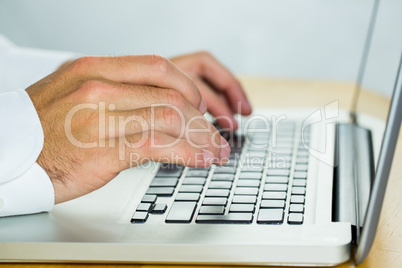 Man using laptop on desk