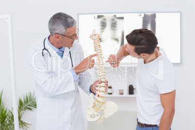 Doctor explaining anatomical spine to his patient