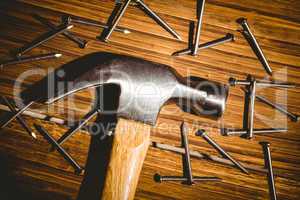 Hammer and nails laid out on table