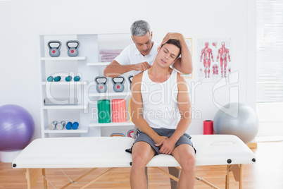 Doctor examining his patient neck