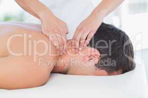 Physiotherapist doing neck massage to her patient