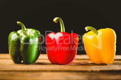 Three peppers on chopping board