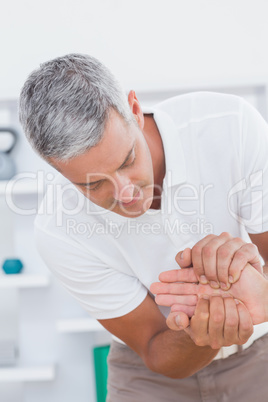 Doctor examining a male patients hand
