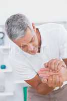 Doctor examining a male patients hand