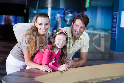 Happy family looking at fish tank