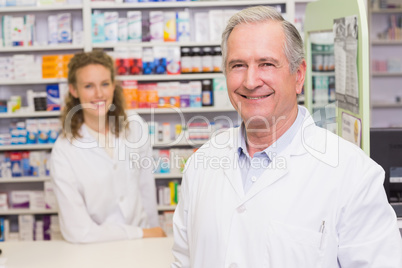 Smiling pharmacists looking at camera